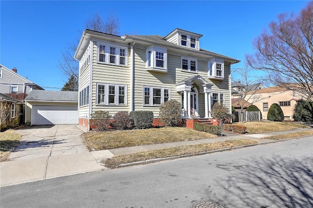 view of front of house featuring a garage, an outbuilding, and driveway