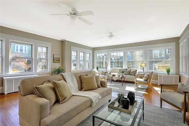 sunroom with radiator and ceiling fan