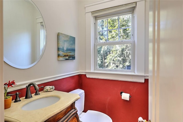 bathroom featuring vanity and toilet