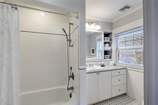 bathroom featuring visible vents, ornamental molding, shower / bath combo with shower curtain, vanity, and tile walls