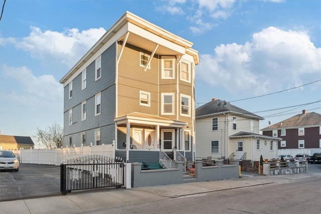 view of front of house featuring a fenced front yard and a gate