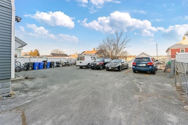 uncovered parking lot featuring fence