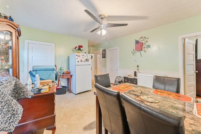 dining space featuring carpet and a ceiling fan