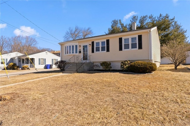 view of front of house featuring a front lawn and a chimney