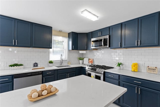 kitchen featuring blue cabinetry, appliances with stainless steel finishes, and a sink