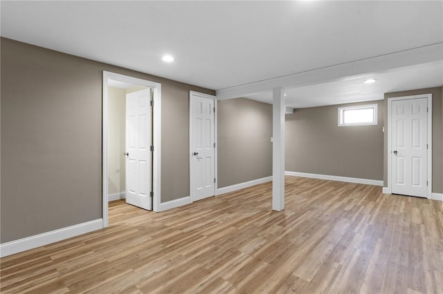 basement with recessed lighting, light wood-style flooring, and baseboards