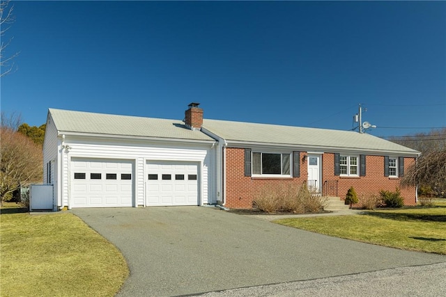 ranch-style house with brick siding, a chimney, a garage, driveway, and a front lawn