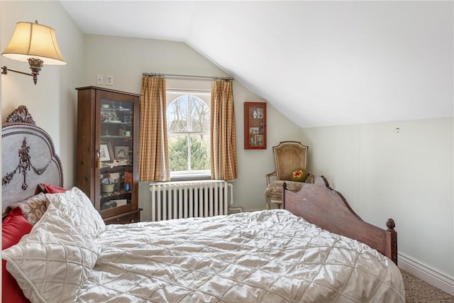 carpeted bedroom with radiator, baseboards, and vaulted ceiling