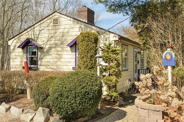 view of property exterior with a chimney