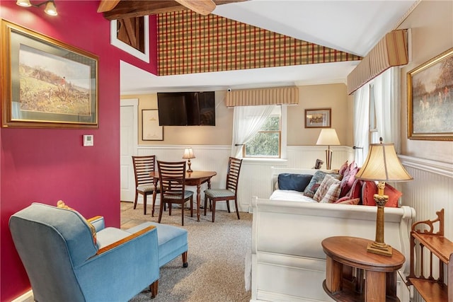 living area featuring carpet floors, vaulted ceiling, and wainscoting