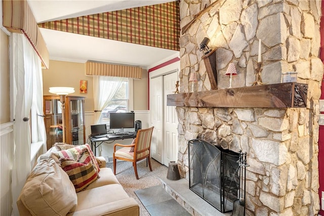 home office featuring carpet flooring, wainscoting, crown molding, and a fireplace