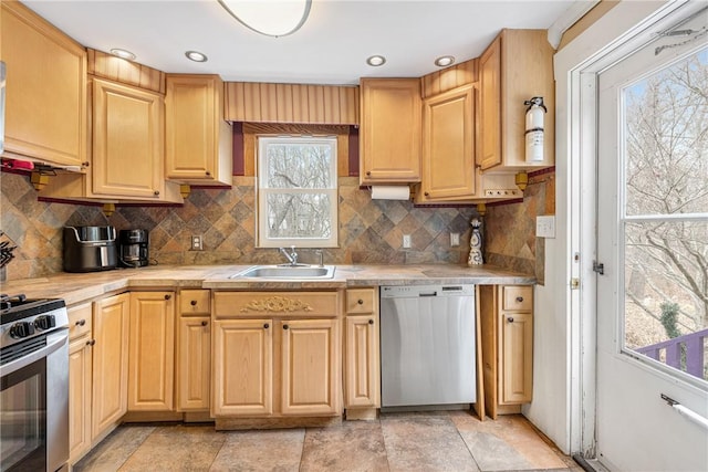 kitchen featuring a sink, stainless steel appliances, light countertops, light brown cabinetry, and backsplash