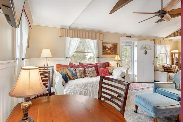 living room with carpet floors, lofted ceiling, wainscoting, and ceiling fan