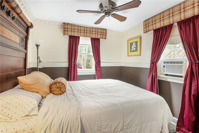 bedroom featuring ceiling fan, ornamental molding, and cooling unit