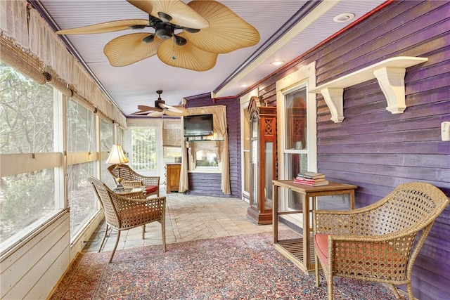 sunroom / solarium with a ceiling fan