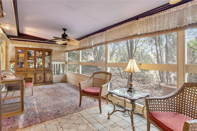 sunroom / solarium with ceiling fan and a healthy amount of sunlight