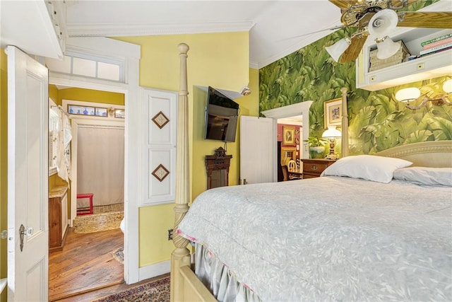 bedroom featuring wallpapered walls, ceiling fan, ornamental molding, and wood finished floors