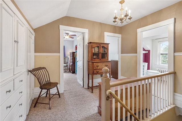 hall featuring light carpet, lofted ceiling, a notable chandelier, and an upstairs landing