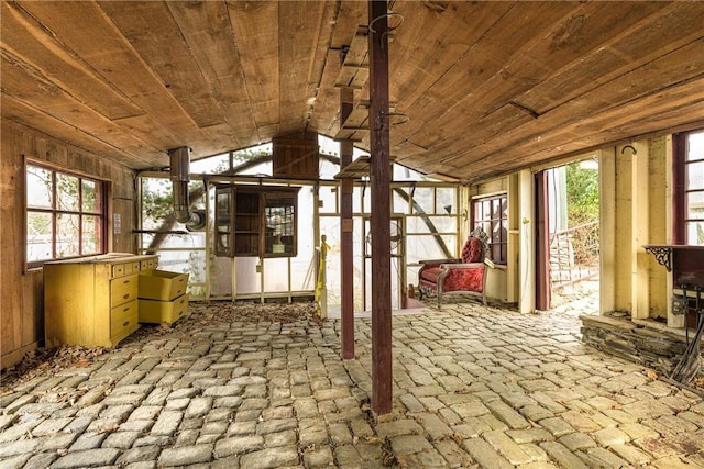 unfurnished sunroom with wooden ceiling and vaulted ceiling