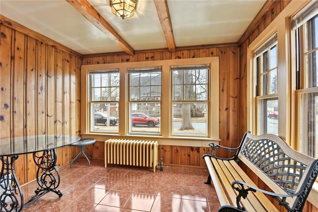 sunroom / solarium with beamed ceiling and radiator