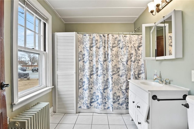 bathroom featuring shower / tub combo, radiator heating unit, tile patterned flooring, and vanity