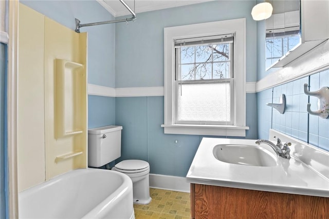 full bathroom featuring toilet, a bathtub, walk in shower, crown molding, and vanity