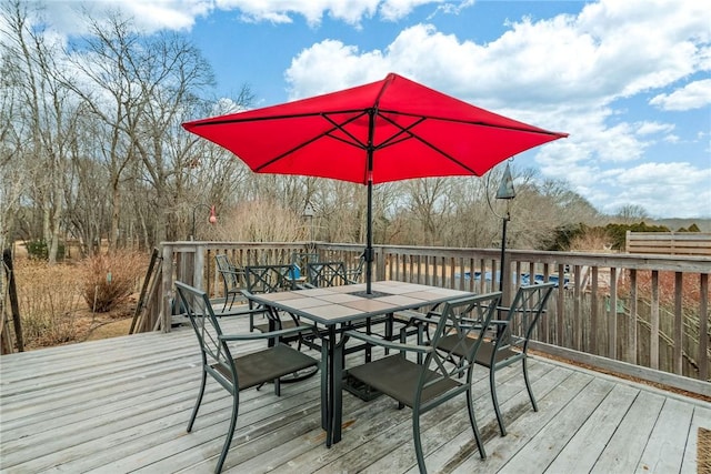 wooden deck with outdoor dining area