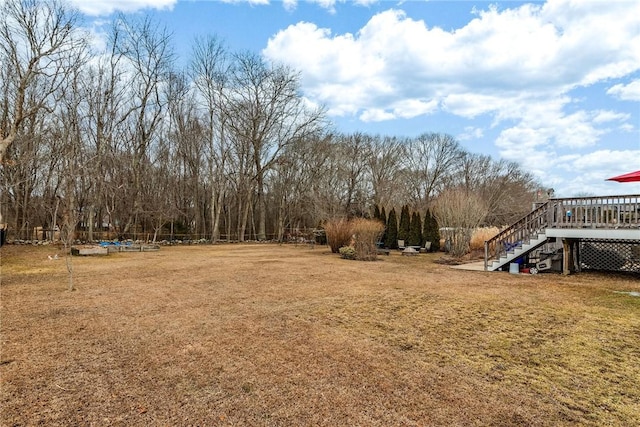 view of yard with a deck and stairs