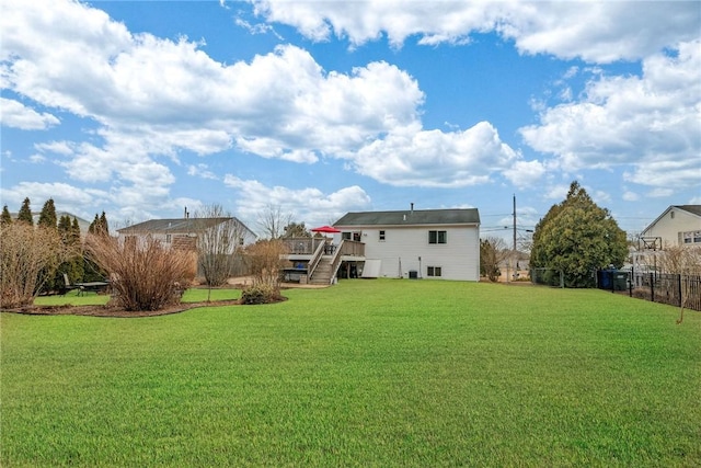 rear view of house featuring stairway, fence, a deck, and a yard