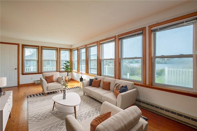 sunroom featuring a baseboard radiator and plenty of natural light