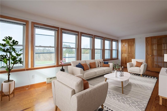 living room featuring baseboard heating and wood finished floors