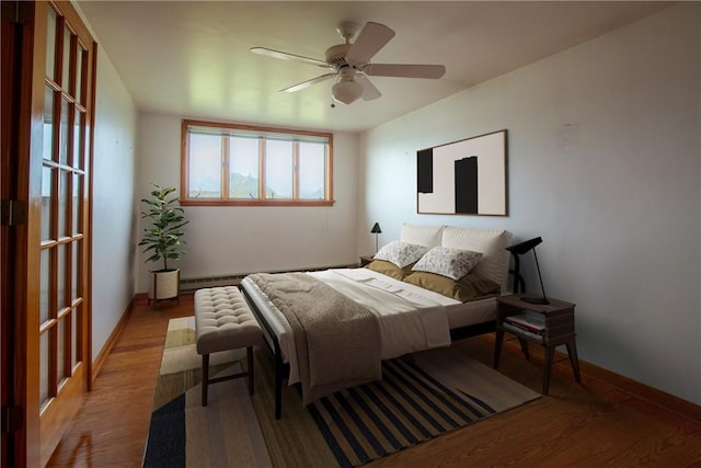 bedroom featuring baseboard heating, a ceiling fan, baseboards, and light wood finished floors