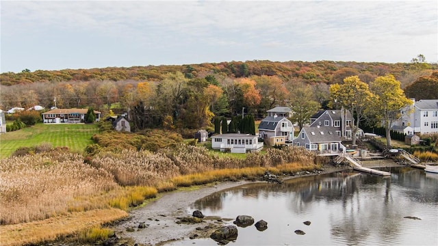 aerial view with a wooded view and a water view