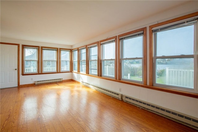 unfurnished sunroom featuring a baseboard radiator