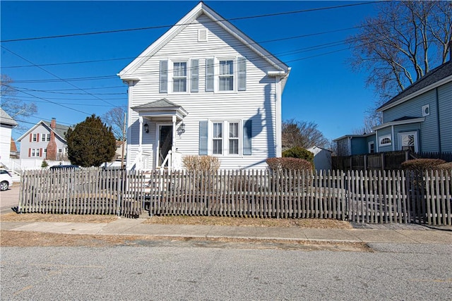 traditional-style home featuring a fenced front yard