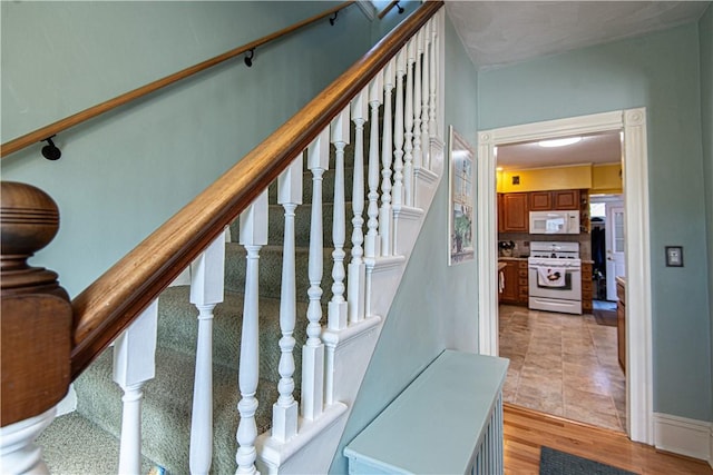 stairs featuring wood finished floors