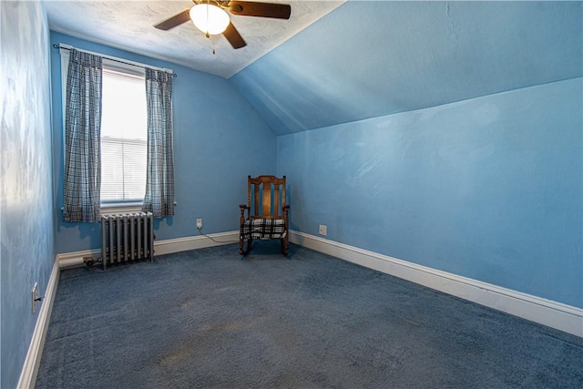 unfurnished room with carpet floors, lofted ceiling, radiator heating unit, ceiling fan, and baseboards