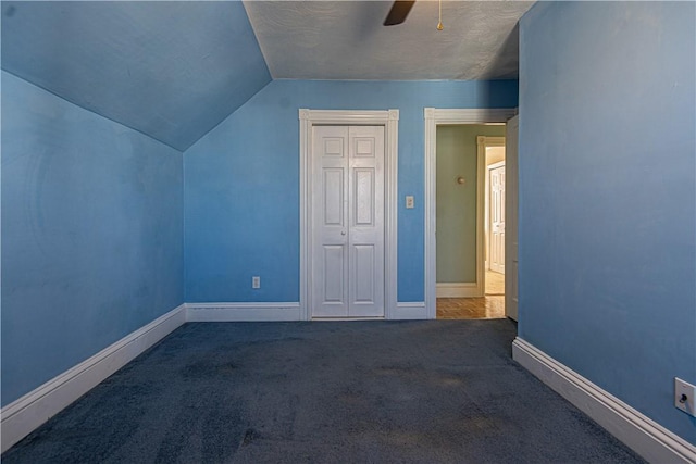 additional living space with a ceiling fan, lofted ceiling, carpet flooring, and baseboards