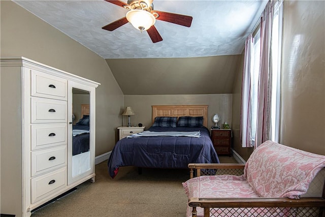 carpeted bedroom with a ceiling fan, lofted ceiling, a textured ceiling, and baseboards