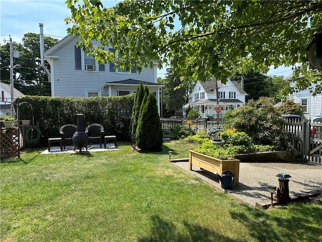 view of yard with a garden and fence