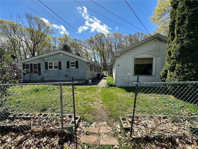 view of property exterior featuring a chimney, fence, a vegetable garden, and a yard