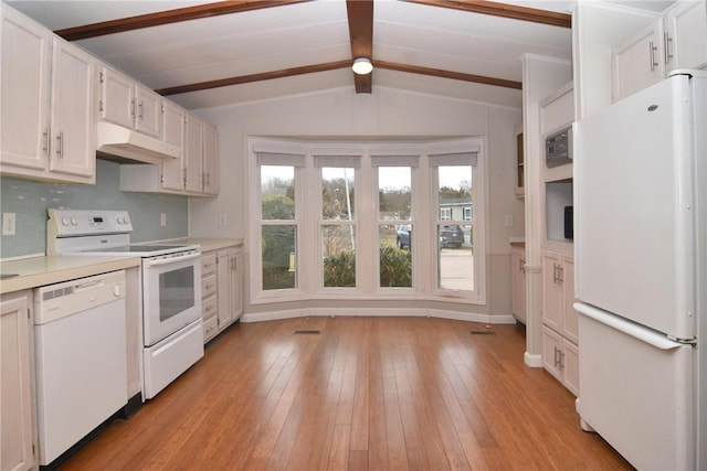 kitchen with lofted ceiling with beams, under cabinet range hood, white appliances, light countertops, and light wood-type flooring