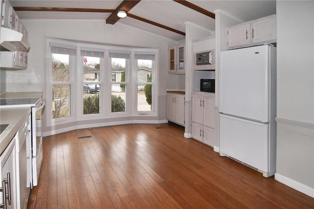 kitchen featuring hardwood / wood-style floors, freestanding refrigerator, vaulted ceiling with beams, under cabinet range hood, and black microwave