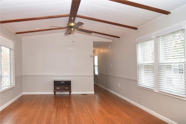 unfurnished living room featuring a ceiling fan, lofted ceiling with beams, baseboards, and wood finished floors