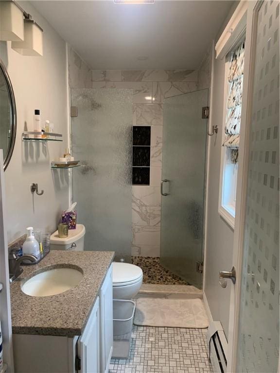 full bathroom featuring toilet, a stall shower, a baseboard radiator, and vanity