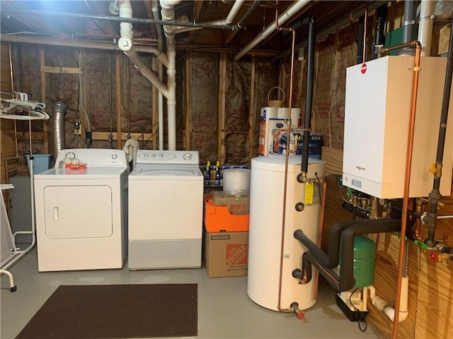 interior space with tankless water heater, water heater, and washing machine and clothes dryer