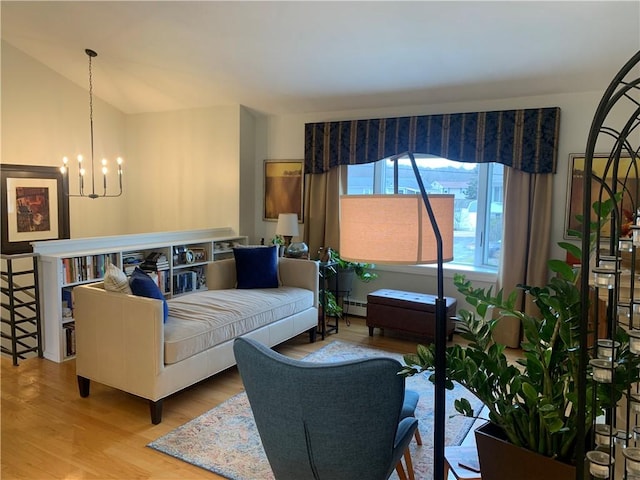 living room featuring lofted ceiling, baseboard heating, wood finished floors, and an inviting chandelier