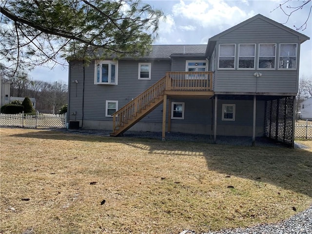 rear view of property featuring a wooden deck, fence, stairway, and a yard