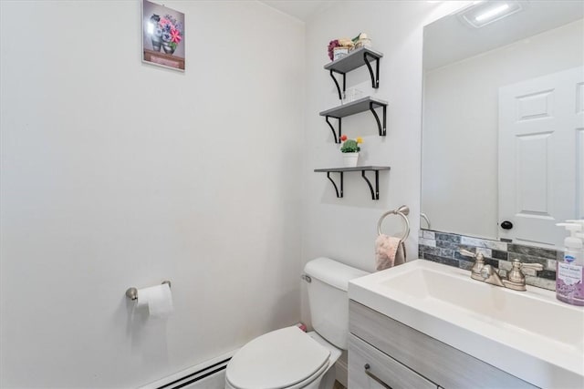 bathroom with tasteful backsplash, vanity, and toilet