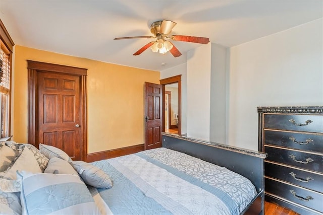 bedroom featuring ceiling fan and baseboards